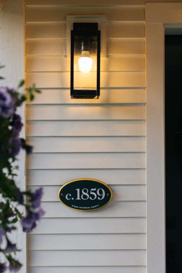 Close-up of historic c.1859 plaque mounted on the farmhouse exterior